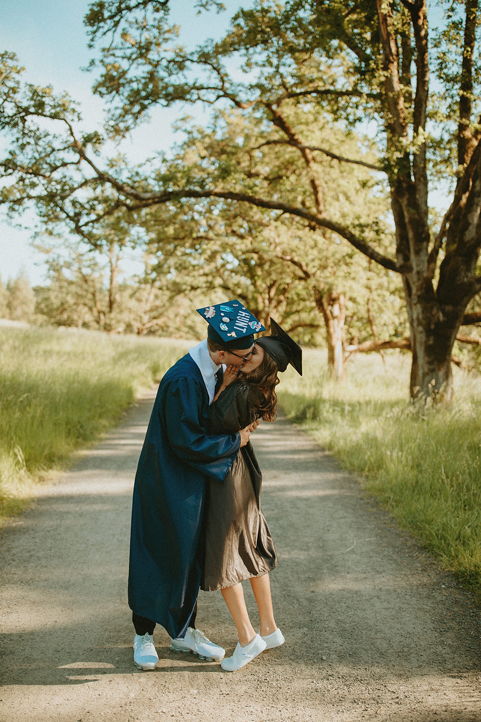 graduation picture of couple kissing